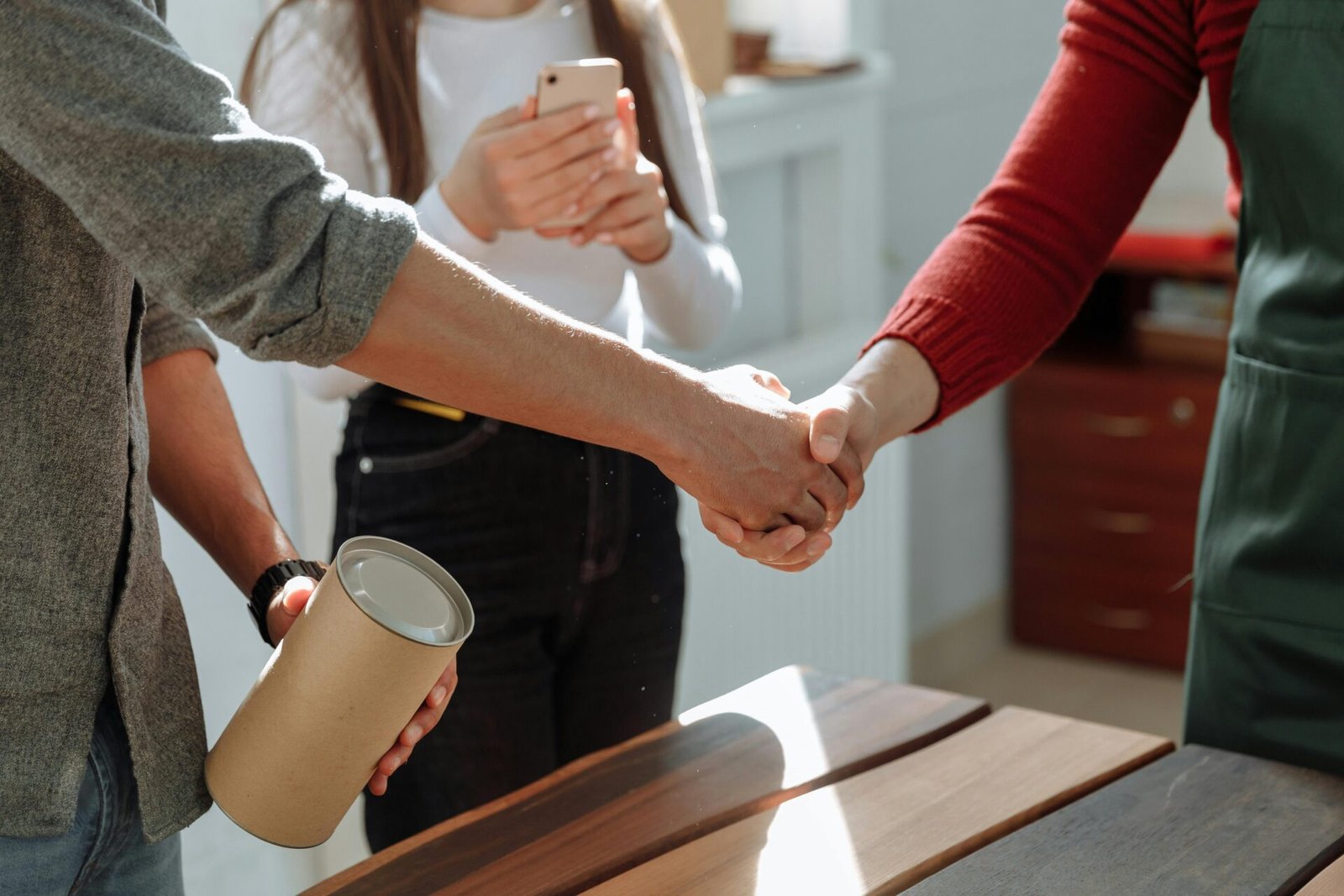 Client shaking hands with a reliable wood floor supplier after successful cooperation