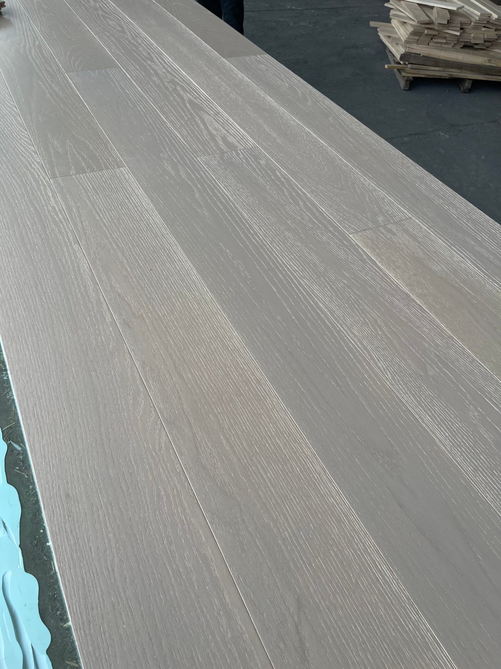 Light-toned red oak flooring boards arranged side by side, showing grain and staggered end joints