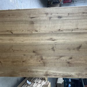 Warm Wheat oak flooring boards showing wheat-brown tones, visible knots, and natural grain variation