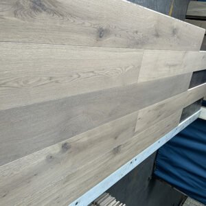 Linen Beige engineered oak flooring boards showing light greige tones, visible knots, and flowing grain patterns
