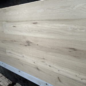 Pearl Beige engineered oak flooring boards showing light beige-gray tones, visible knots, and natural grain variation