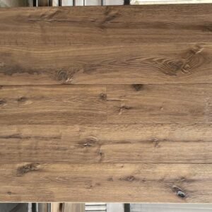 Axe hewn oak flooring display showing pronounced grain texture, knots, and natural tonal variation
