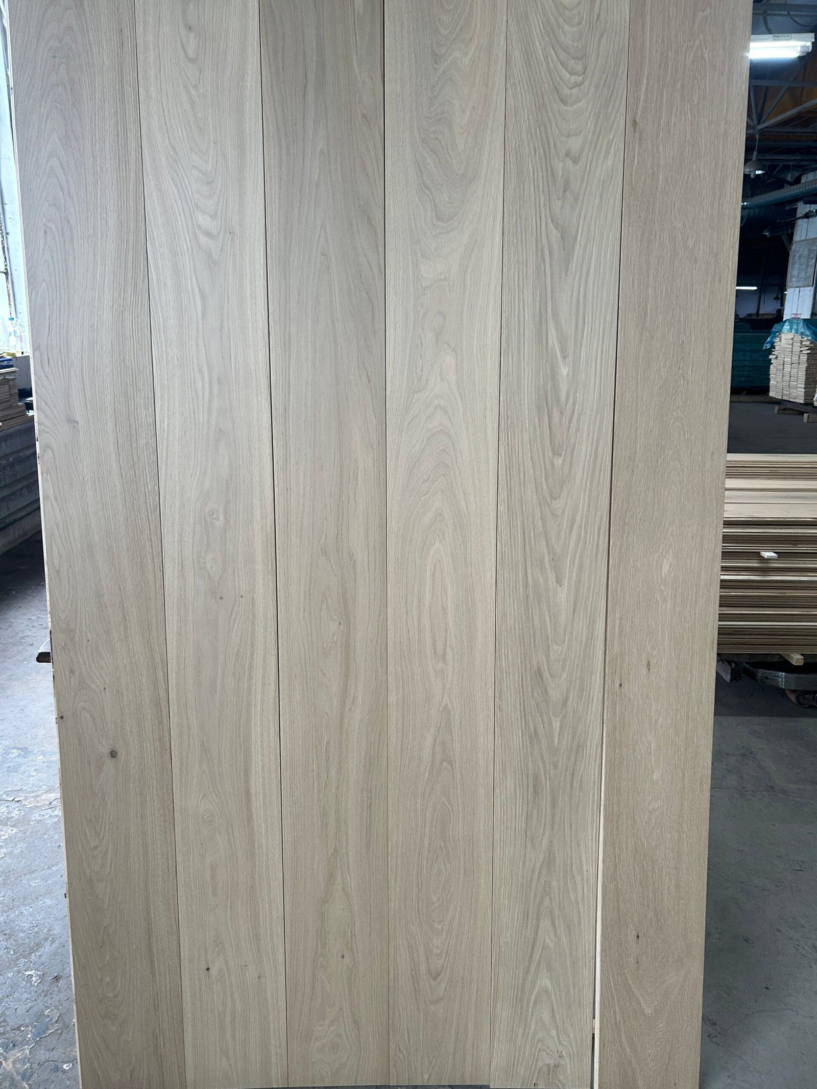 Pearl Beige engineered oak flooring boards displayed upright, showing light beige-gray tones and natural grain variation