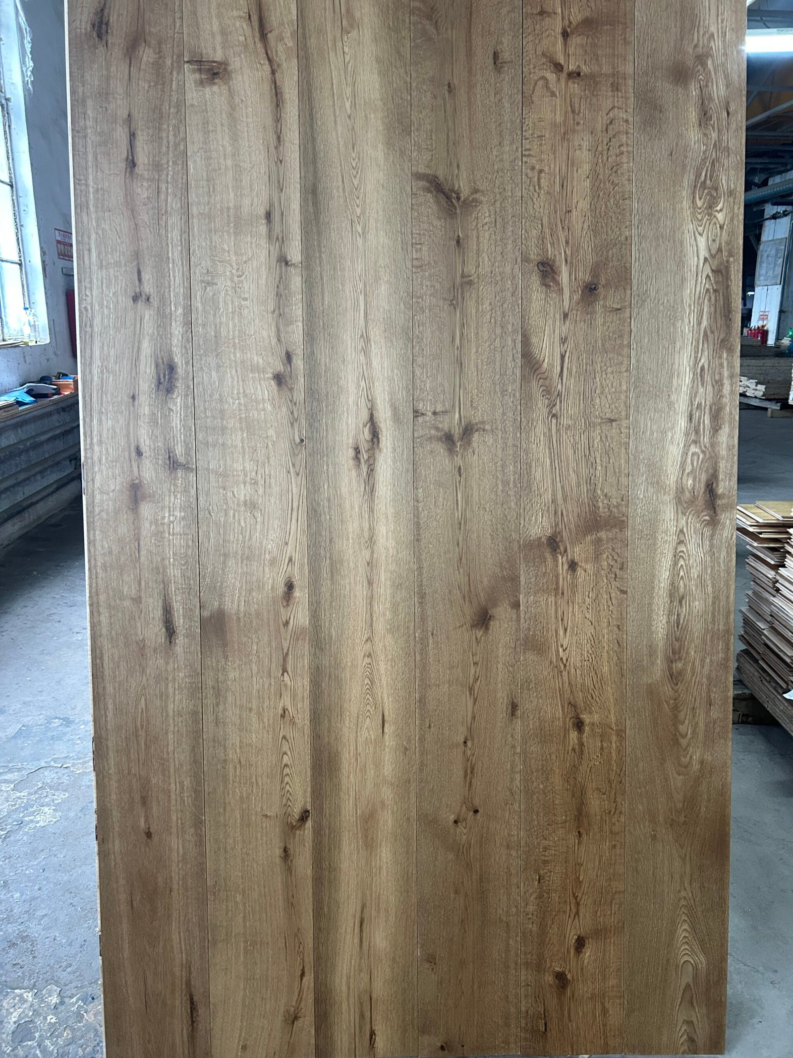 Warm Wheat engineered oak flooring boards displayed upright, showing warm brown tones, visible knots, and contrasting grain