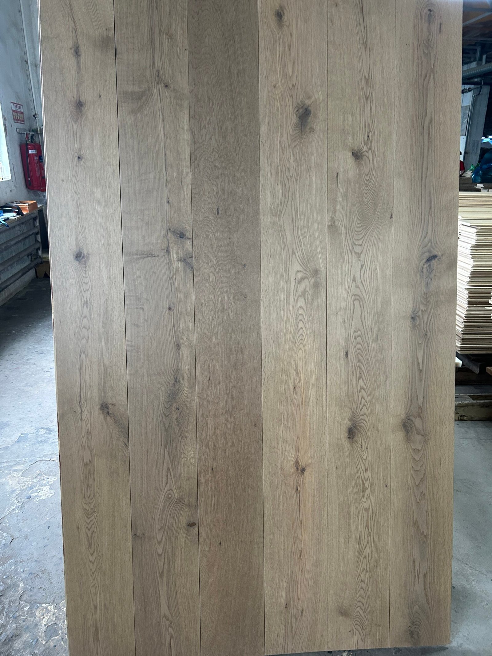 Mist Grey engineered oak flooring boards displayed upright, showing visible knots, flowing grain, and tonal variation