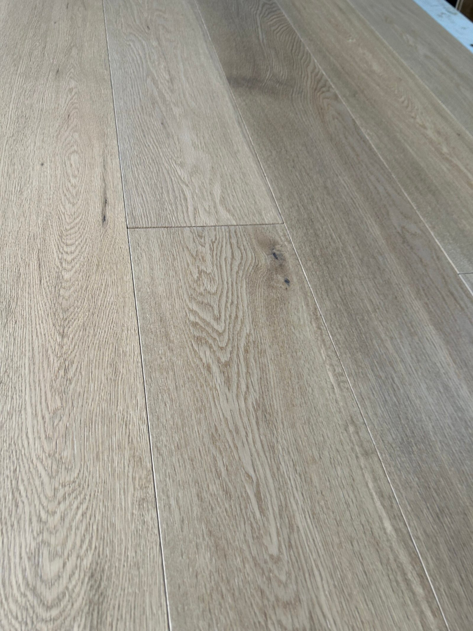 Close-up of Mist Grey oak flooring showing natural grain, visible knots, and staggered board joints
