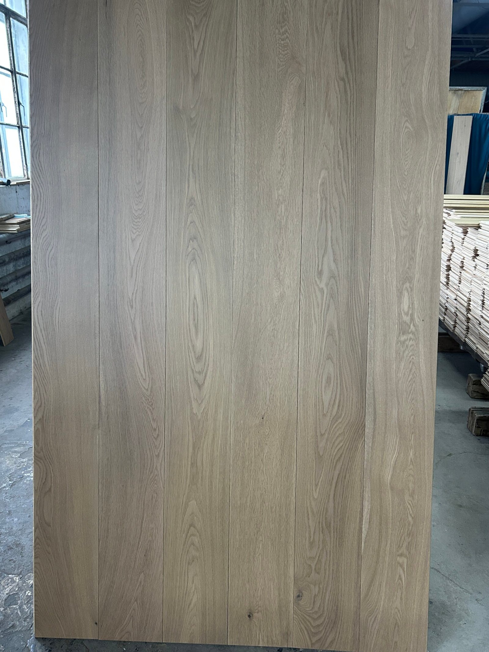 Mist Grey engineered oak flooring boards displayed upright, showing soft gray tones and natural grain variation