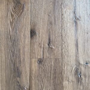 Axe hewn oak flooring showing textured grain, visible knots, and variation across adjacent boards